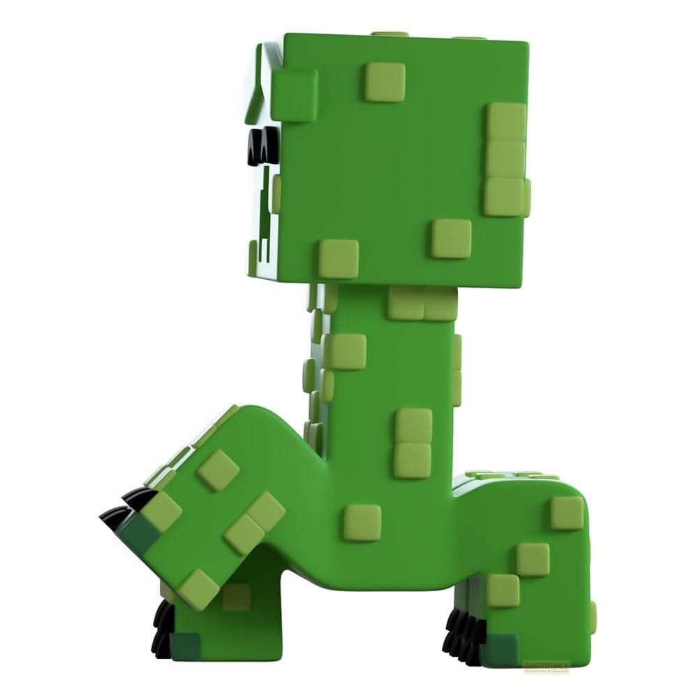 Creeper verde de Minecraft con diseño de píxeles y pies negros. Está agachado.