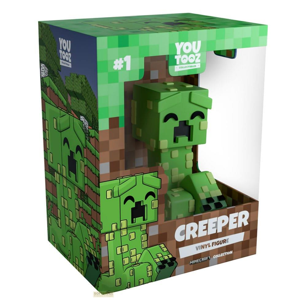 Figura verde de Creeper de Minecraft en empaque You Tooz con diseño de bosque y tierra.