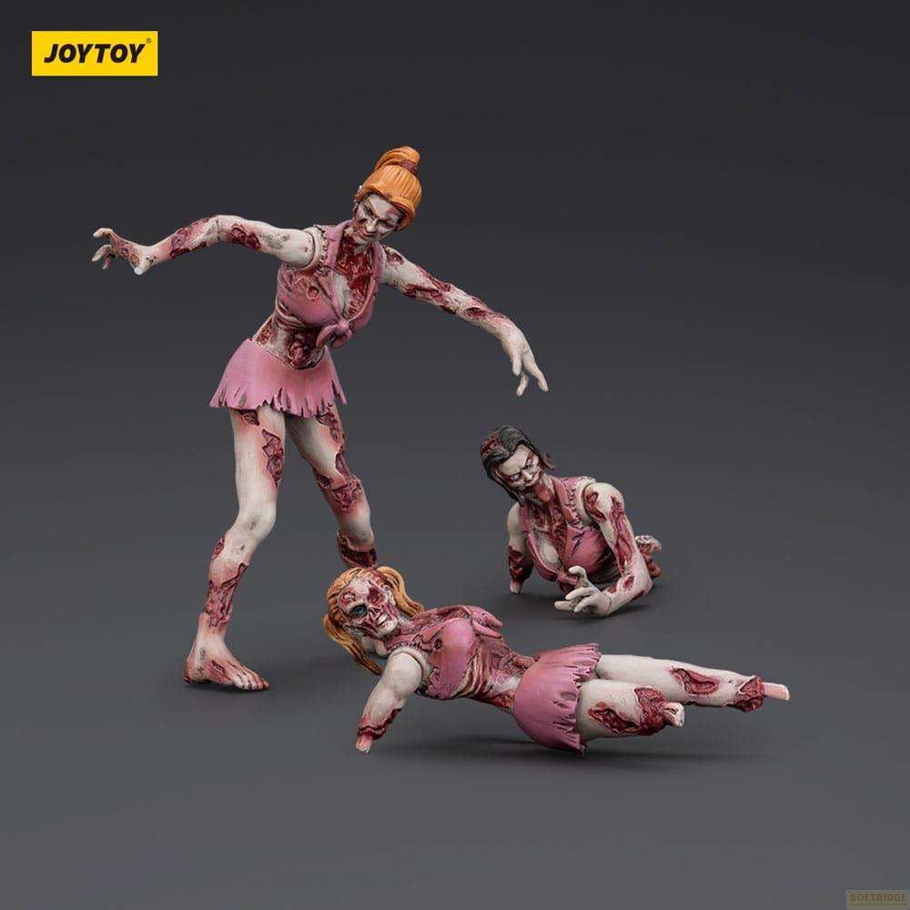 Tre figure di zombie in abiti rosa su sfondo grigio. Una in piedi, due sdraiate.