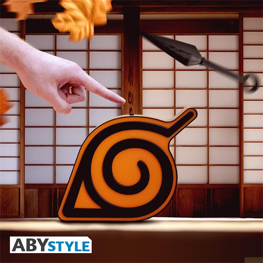 Un dedo señala un símbolo naranja con espirales negras. Un shuriken pasa volando.