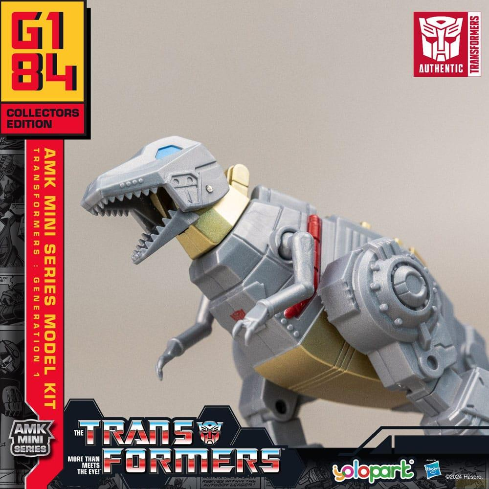 Ein grauer Dinosaurier-Roboter mit goldenen Akzenten steht im Vordergrund. G1 84.