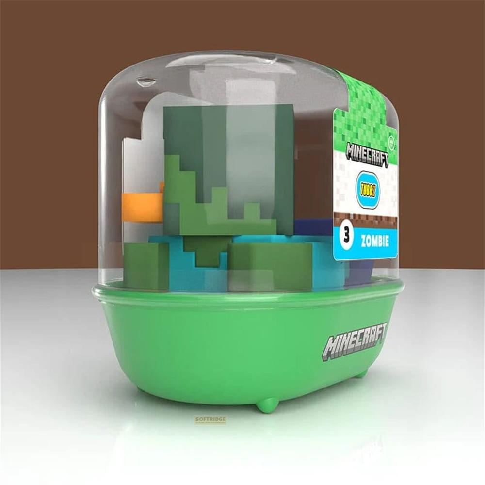 Minecraft Spielzeug mit grüner Basis und transparentem Deckel, enthält bunte Blöcke.