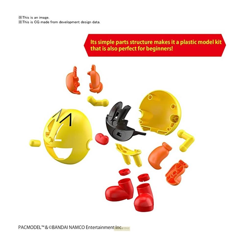 Bunte Teile eines Pac-Man-Modellbausatzes liegen verstreut auf weißem Hintergrund.