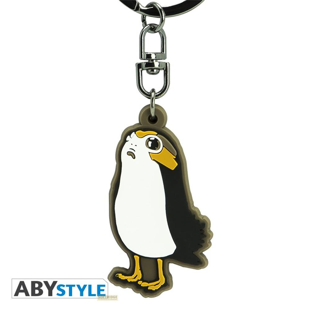 Un llavero con un personaje Porg. Pecho blanco, cuerpo negro, pies amarillos.