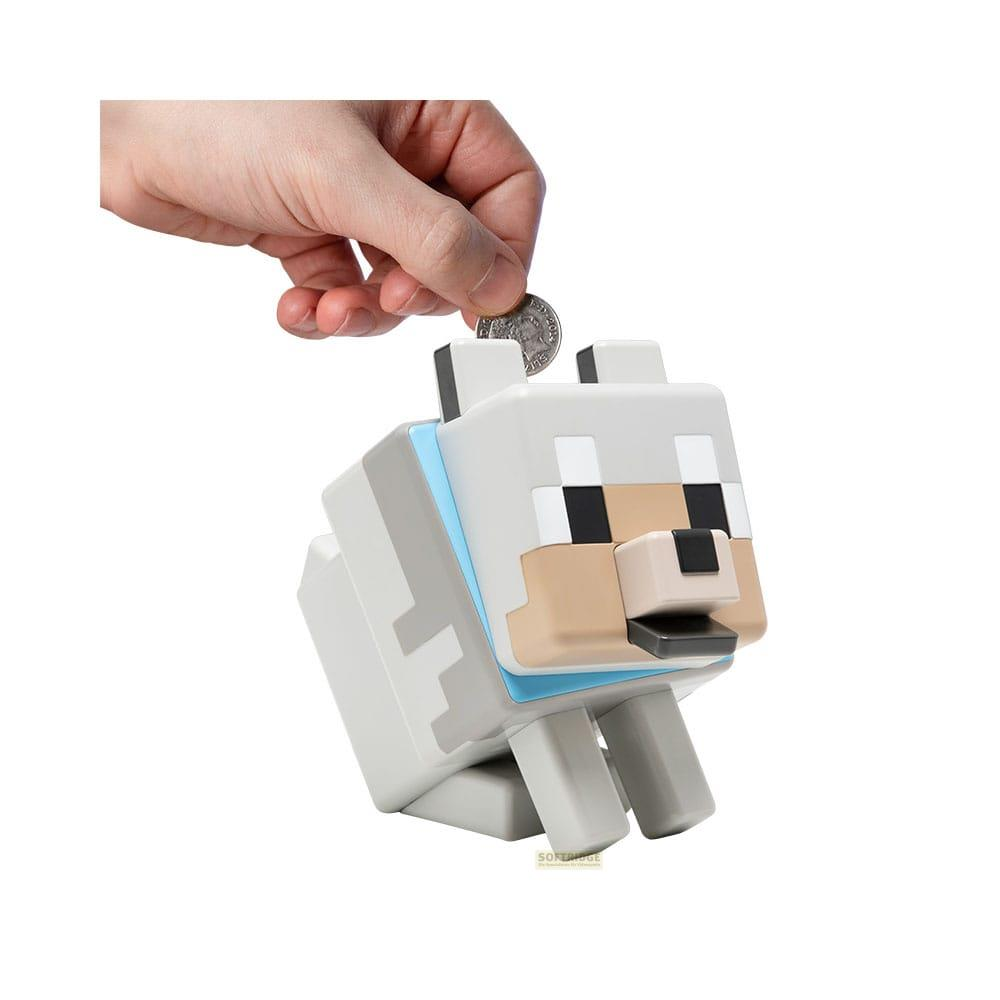 Ręka wrzuca monetę do głowy świnki-skarbonki Minecraft wilka.