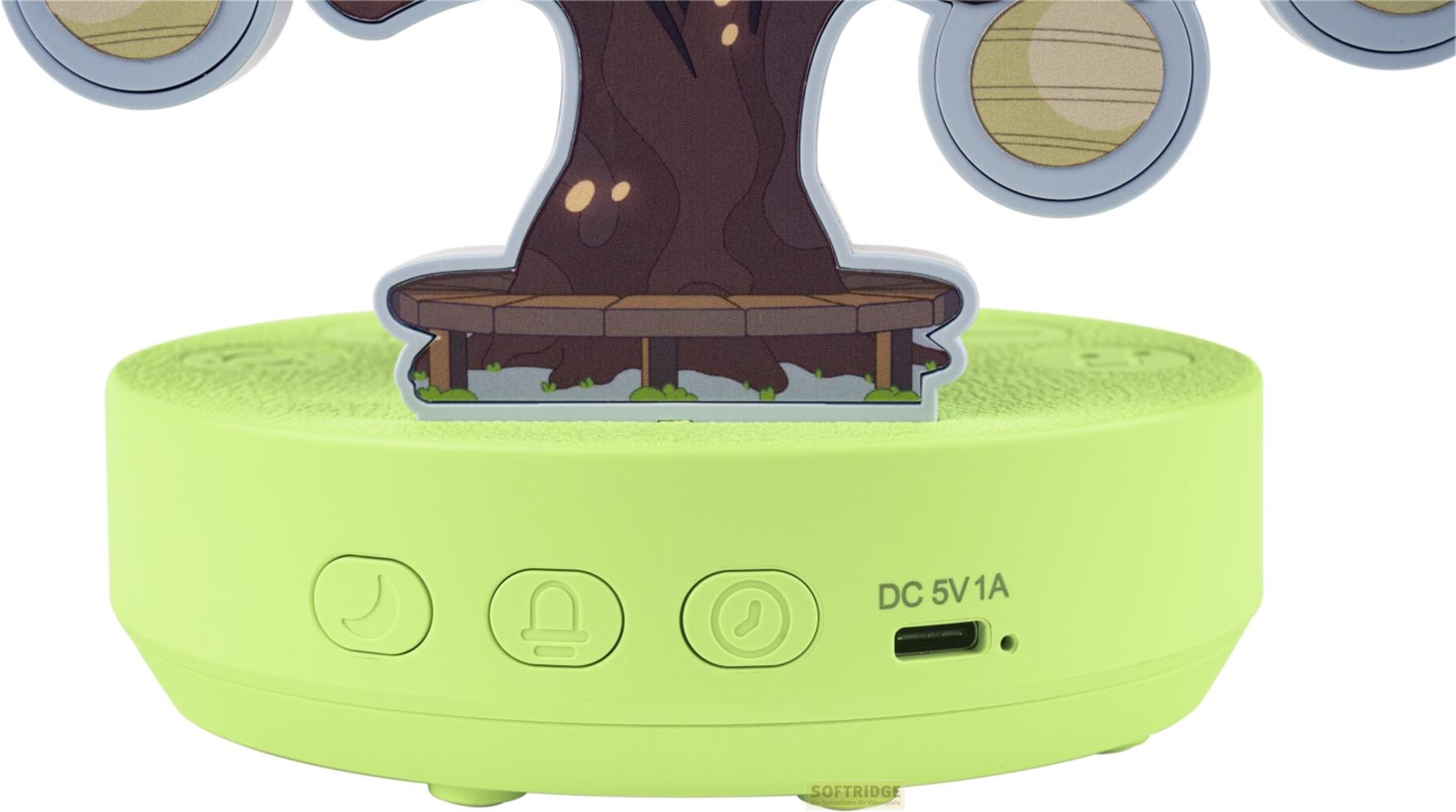 Un appareil vert avec un design d'arbre et des boutons. Un port USB-C est visible.