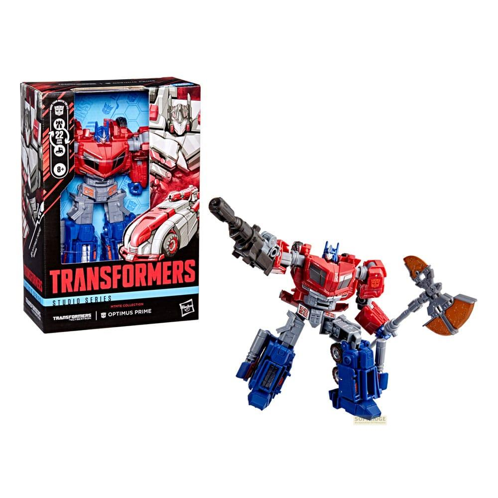 Juguete Optimus Prime con hacha y pistola, junto a su caja.