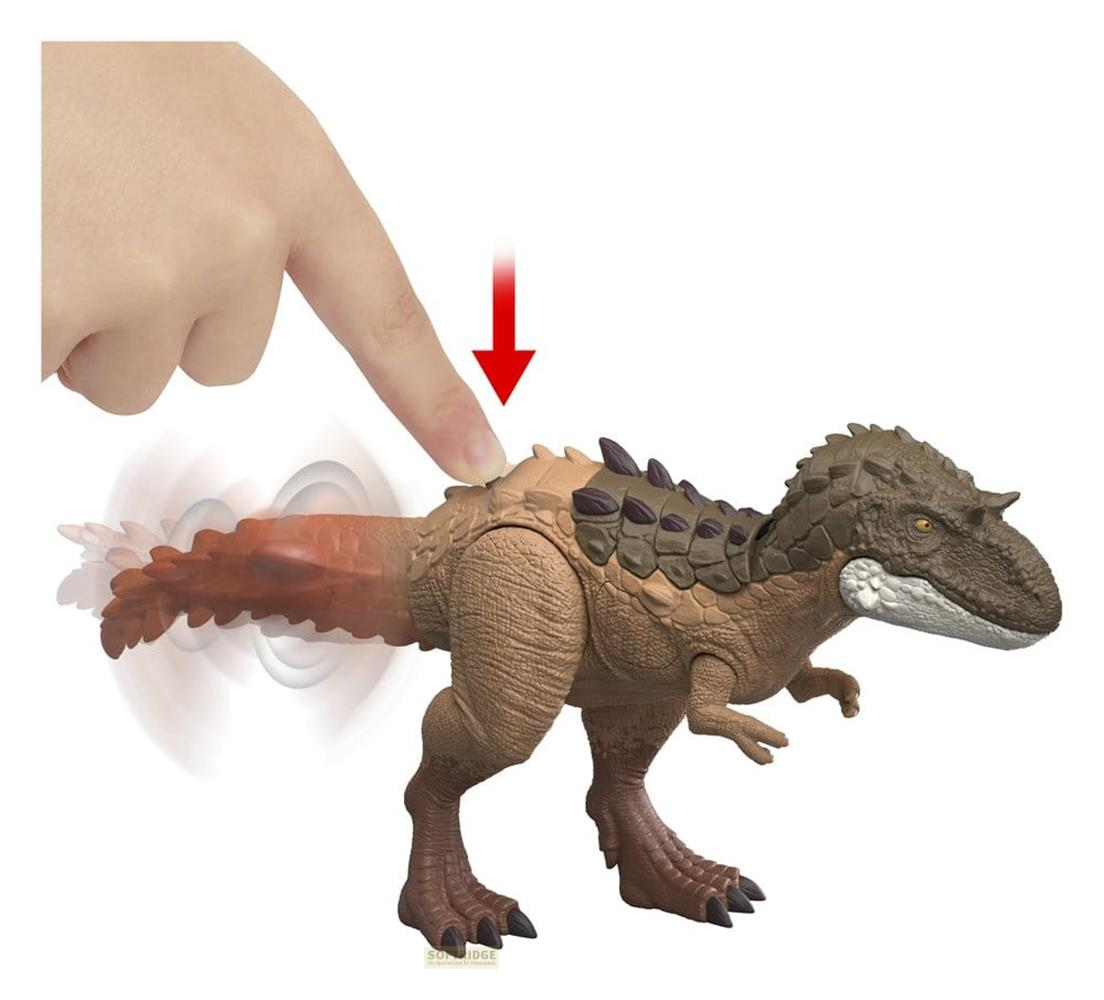 Ein Finger drückt auf einen braunen Dinosaurier-Spielzeug, der den Schwanz bewegt.