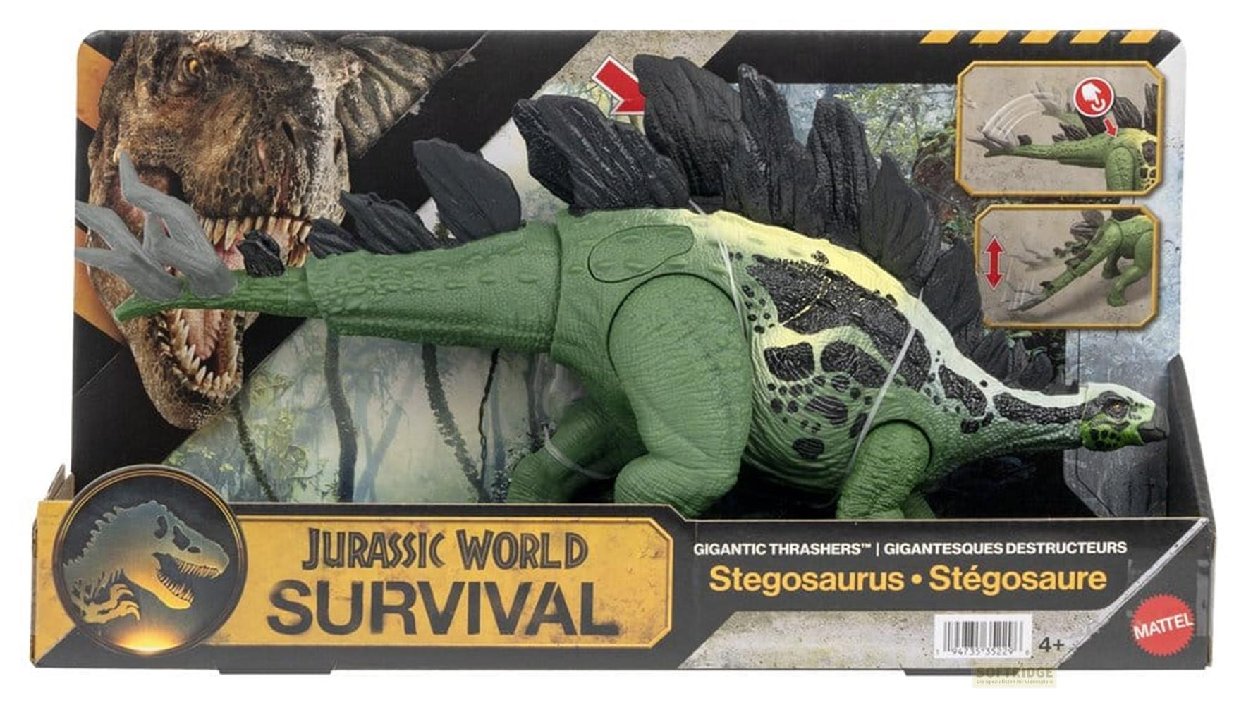 Grüner Stegosaurus Spielzeug Dinosaurier im Karton neben einem T-Rex Kopf.