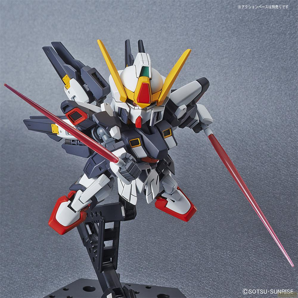 Un petit robot blanc, gris et rouge tenant des sabres laser rouges sur un support noir.