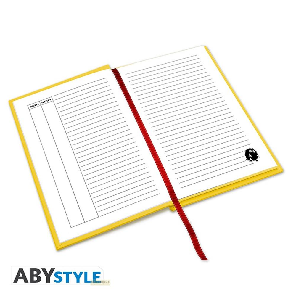 Un carnet ouvert à couverture jaune avec pages lignées. Un marque-page rouge. Joueur 1, Joueur 2.