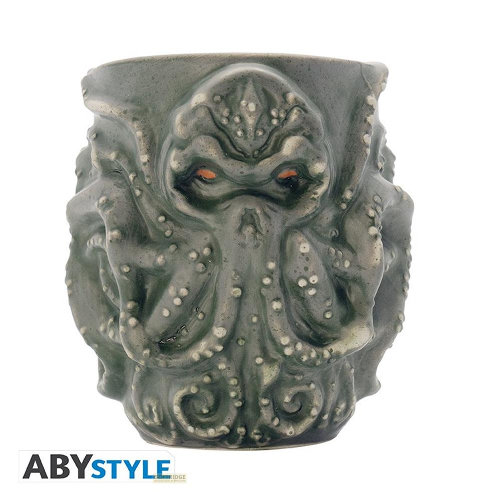 Taza gris con diseño de tentáculos y ojos naranjas.