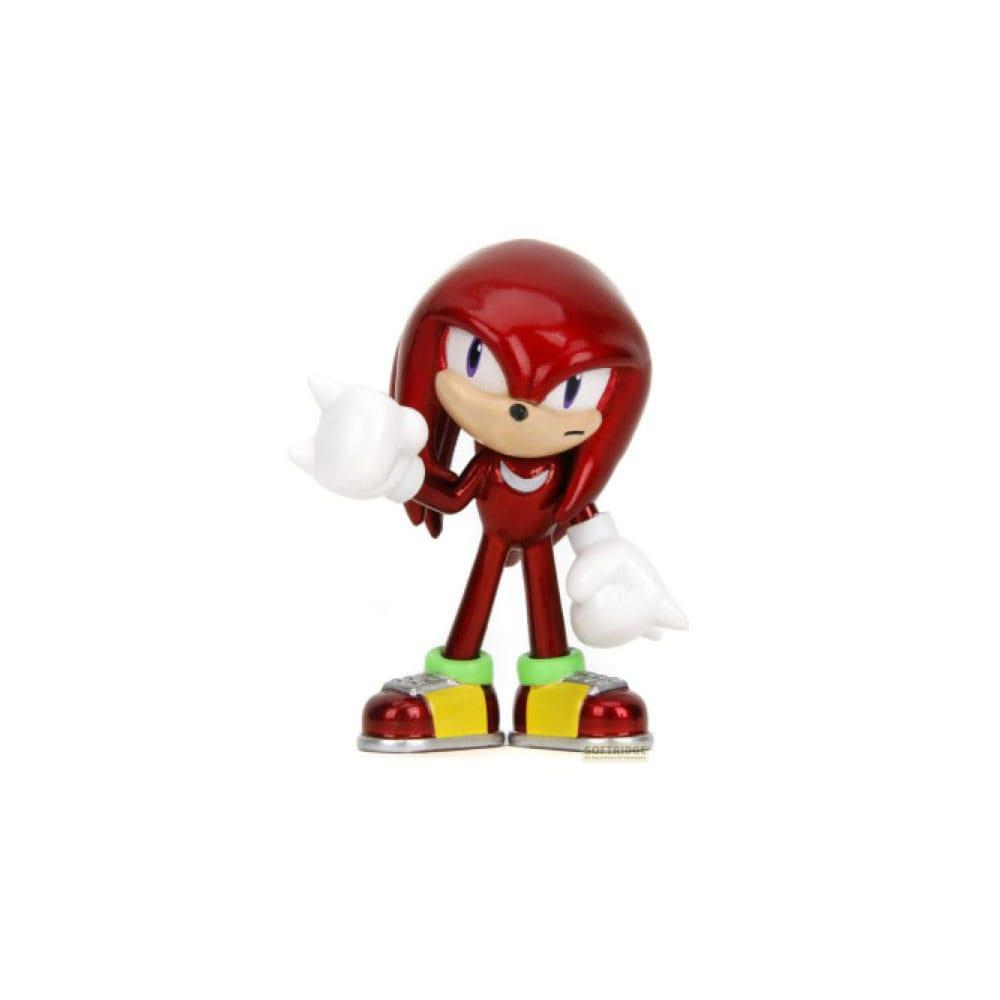 Una figura roja con guantes blancos y zapatos verdes se alza de perfil.