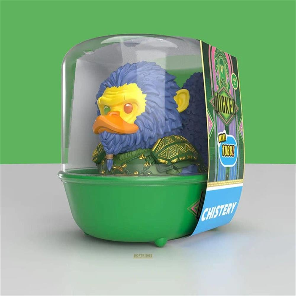 Ein Spielzeug mit blauem Fell, Entenschnabel und gelbem Gesicht in grüner Verpackung.