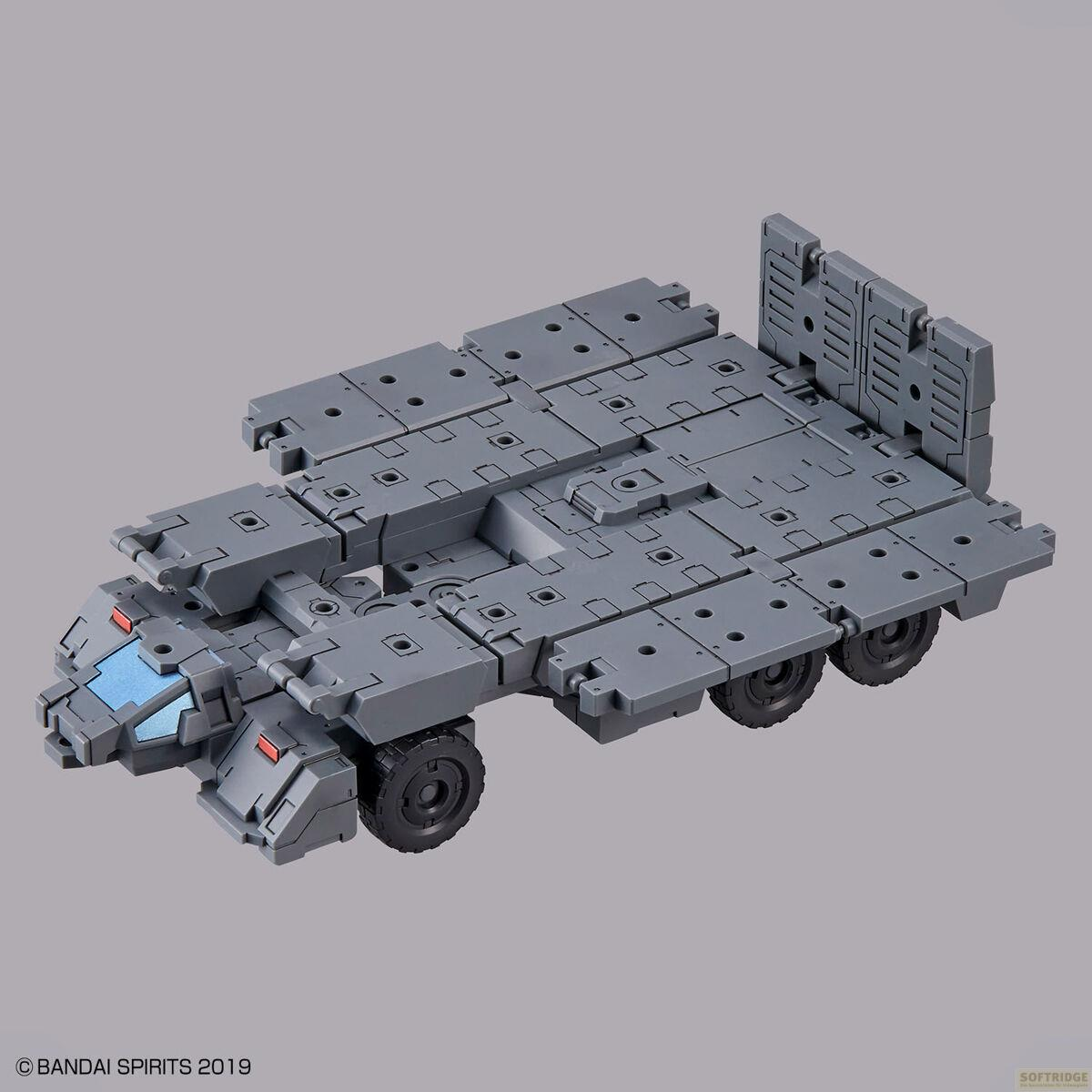 Modèle de véhicule modulaire gris à six roues et fenêtres bleues.