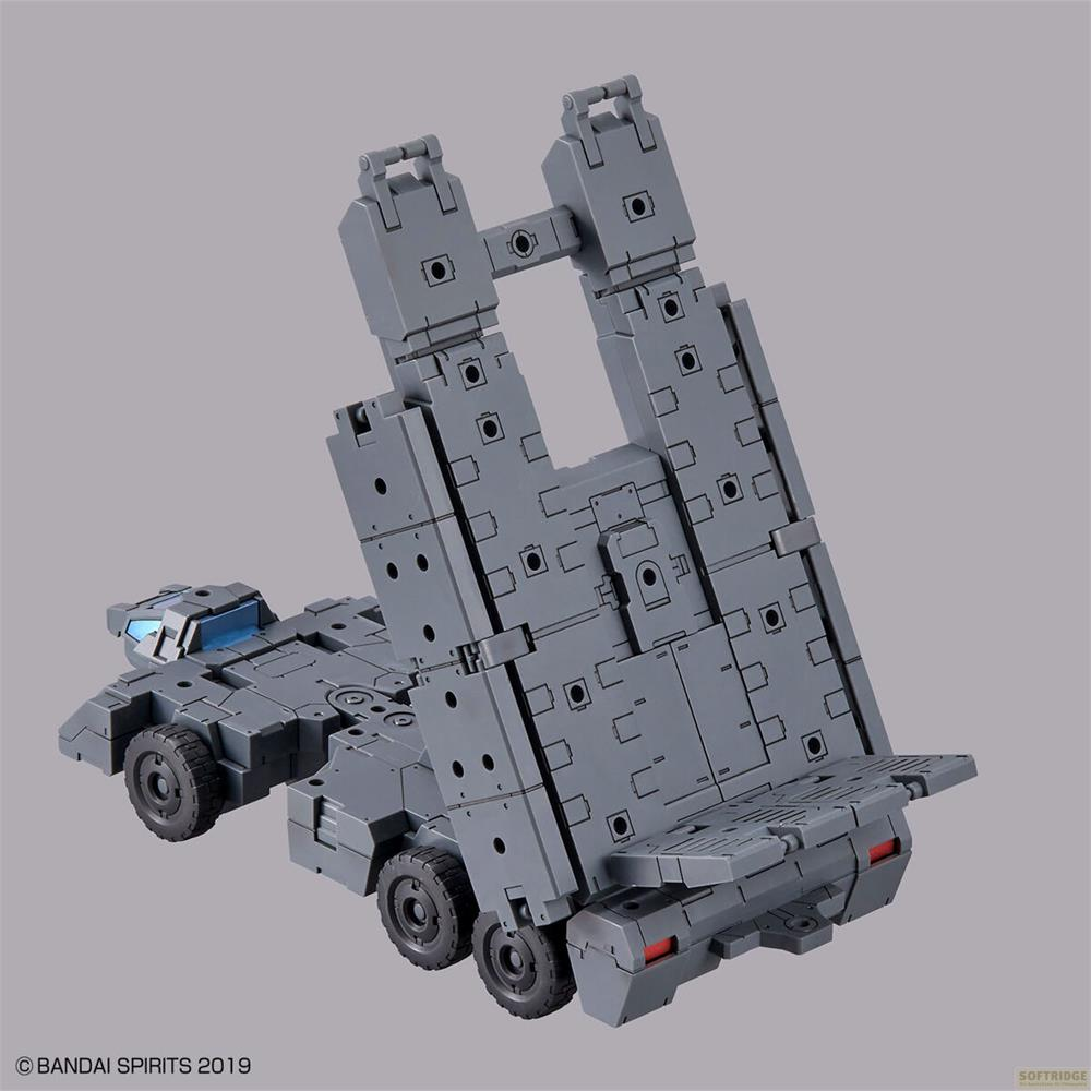 Camion modèle gris avec remorque surélevée et fenêtres bleues.
