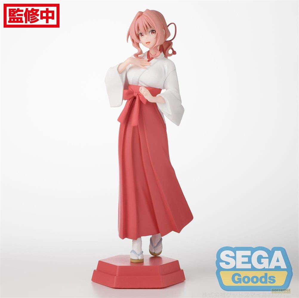Eine Figur einer Frau in traditioneller japanischer Kleidung, weißes Oberteil, roter Rock.