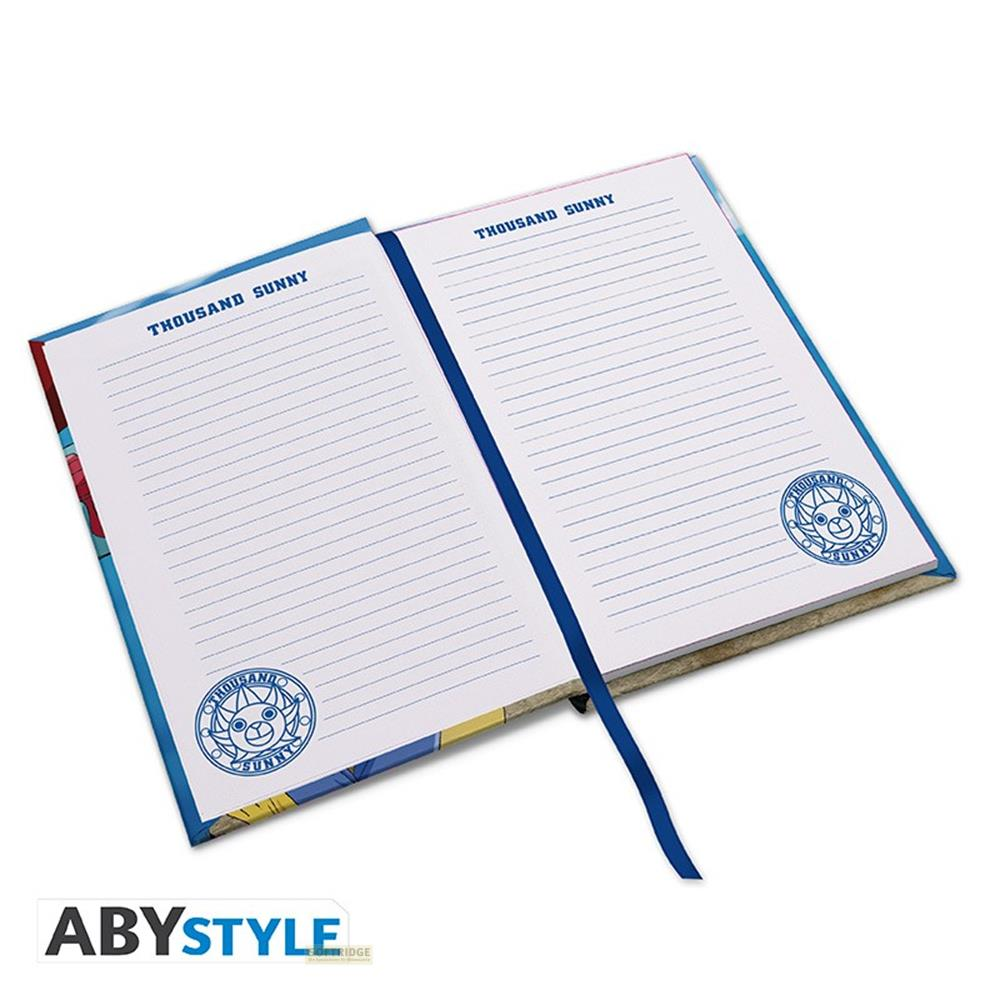 Un carnet ouvert avec pages lignées et le logo Thousand Sunny.