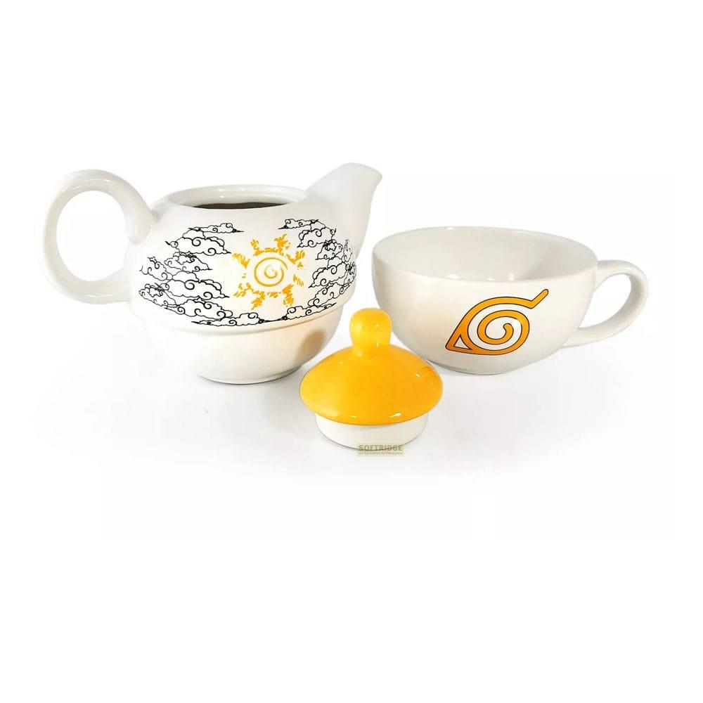 Weiße Teekanne mit Wolken und Sonne, Tasse mit Blatt-Symbol, gelber Deckel.