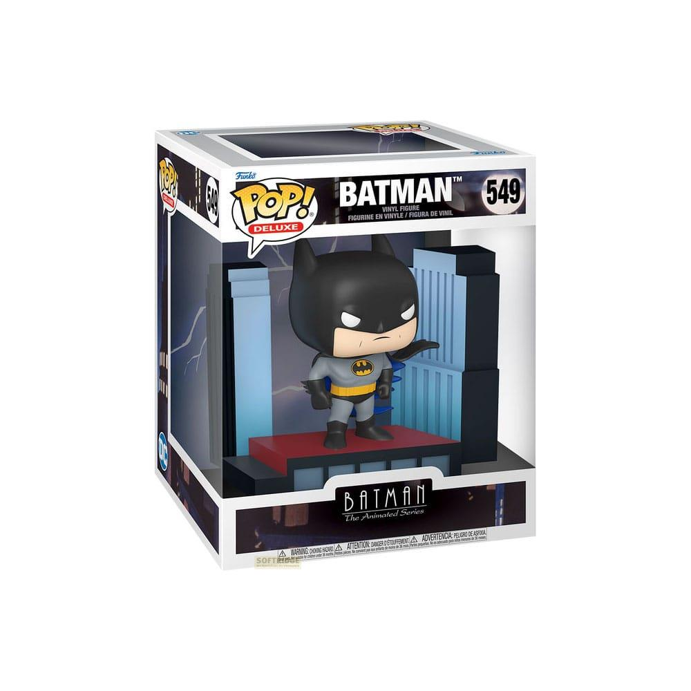 Figura de Batman en caja, traje gris, cinturón amarillo, telón de fondo azul.