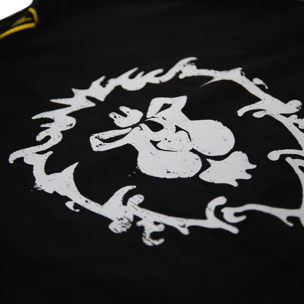 Schwarzes T-Shirt mit Emblem. Gelber Besatz an Schulter.