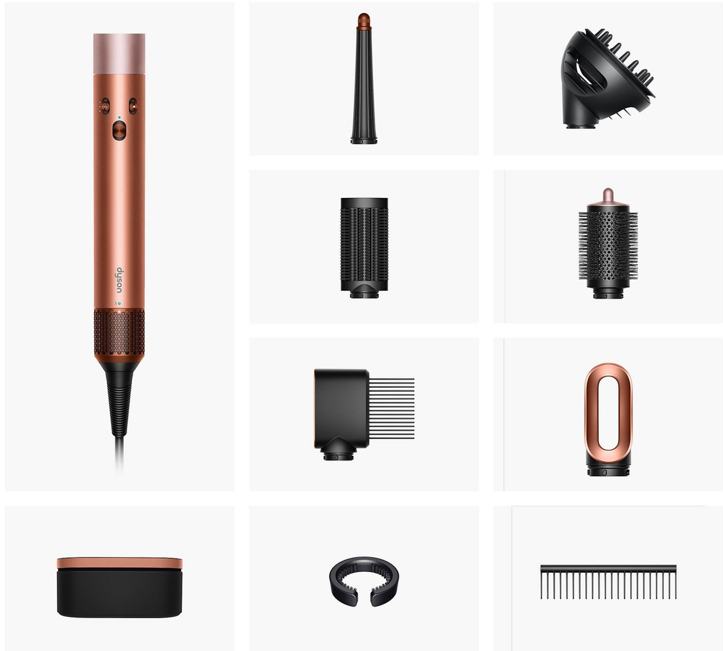 Ein roségoldener Haartrockner mit Zubehörteilen: Aufsätze, Bürsten, ein Kamm und eine Aufbewahrungsbox.