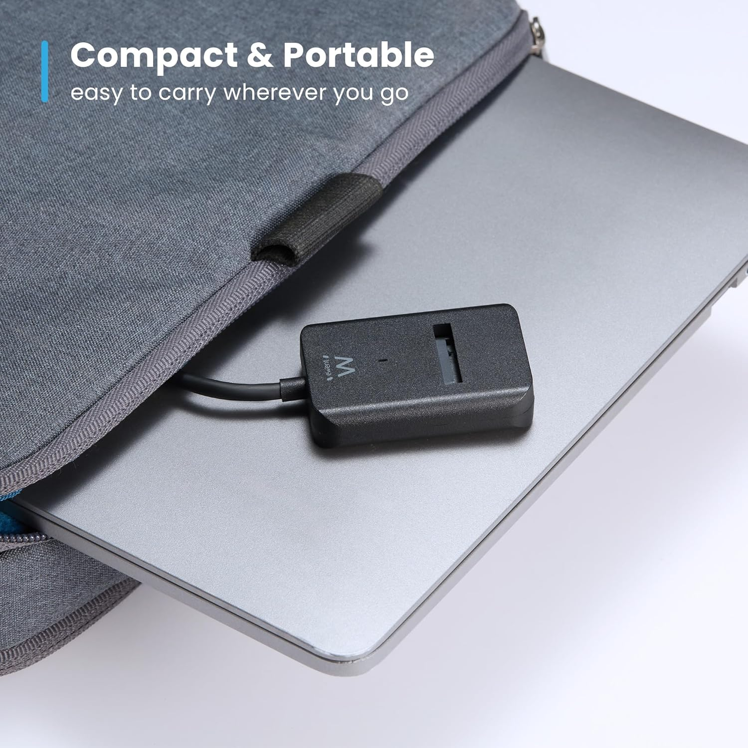 Un hub USB-C nero su un laptop argentato, parzialmente in una custodia grigia.