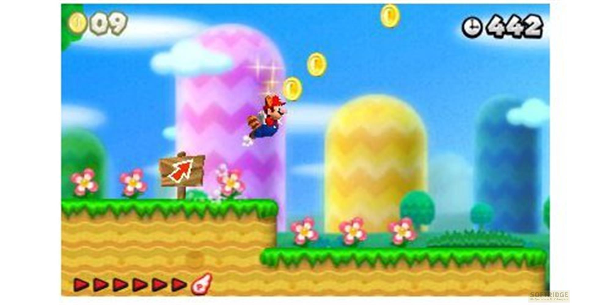 Mario springt in einer hellen Welt mit Münzen, Blumen und bunten Hügeln.