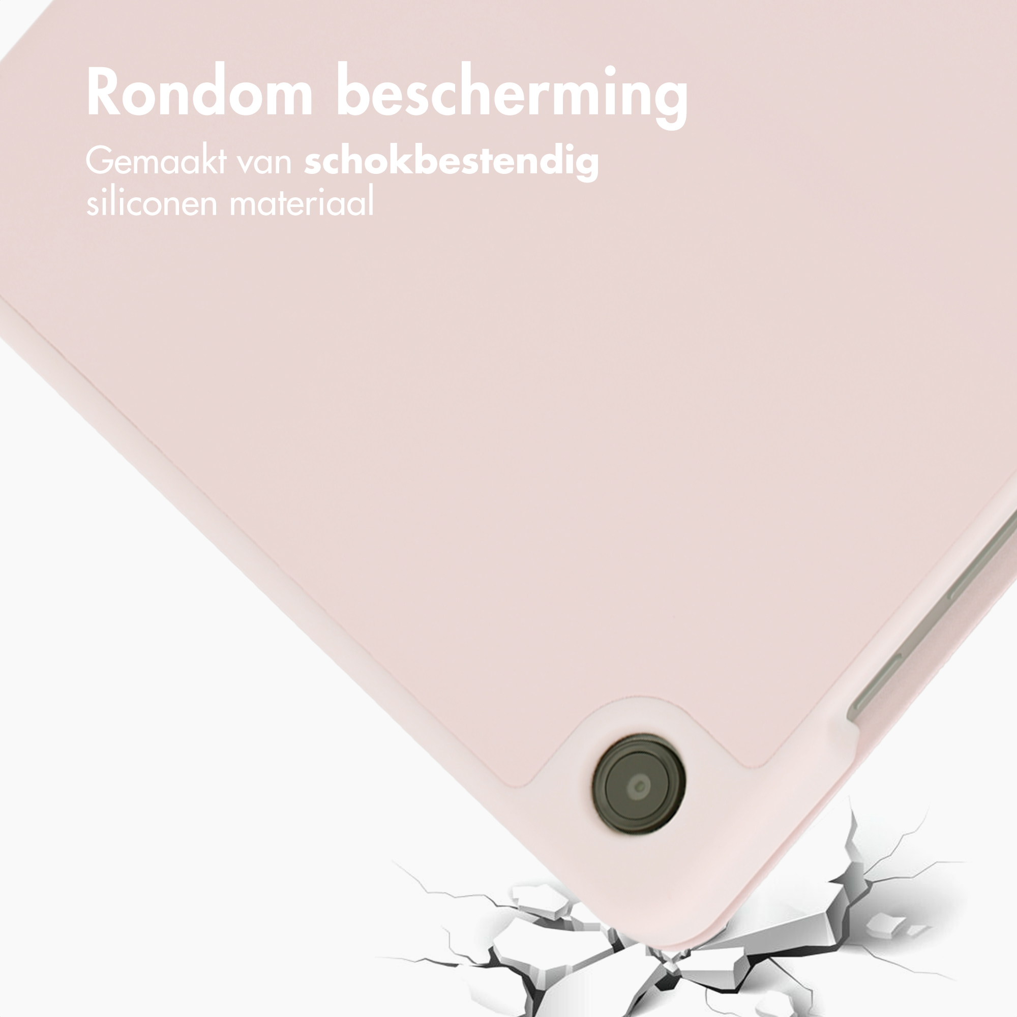 A pink silicone tablet case with camera hole, falling onto cracked ground.