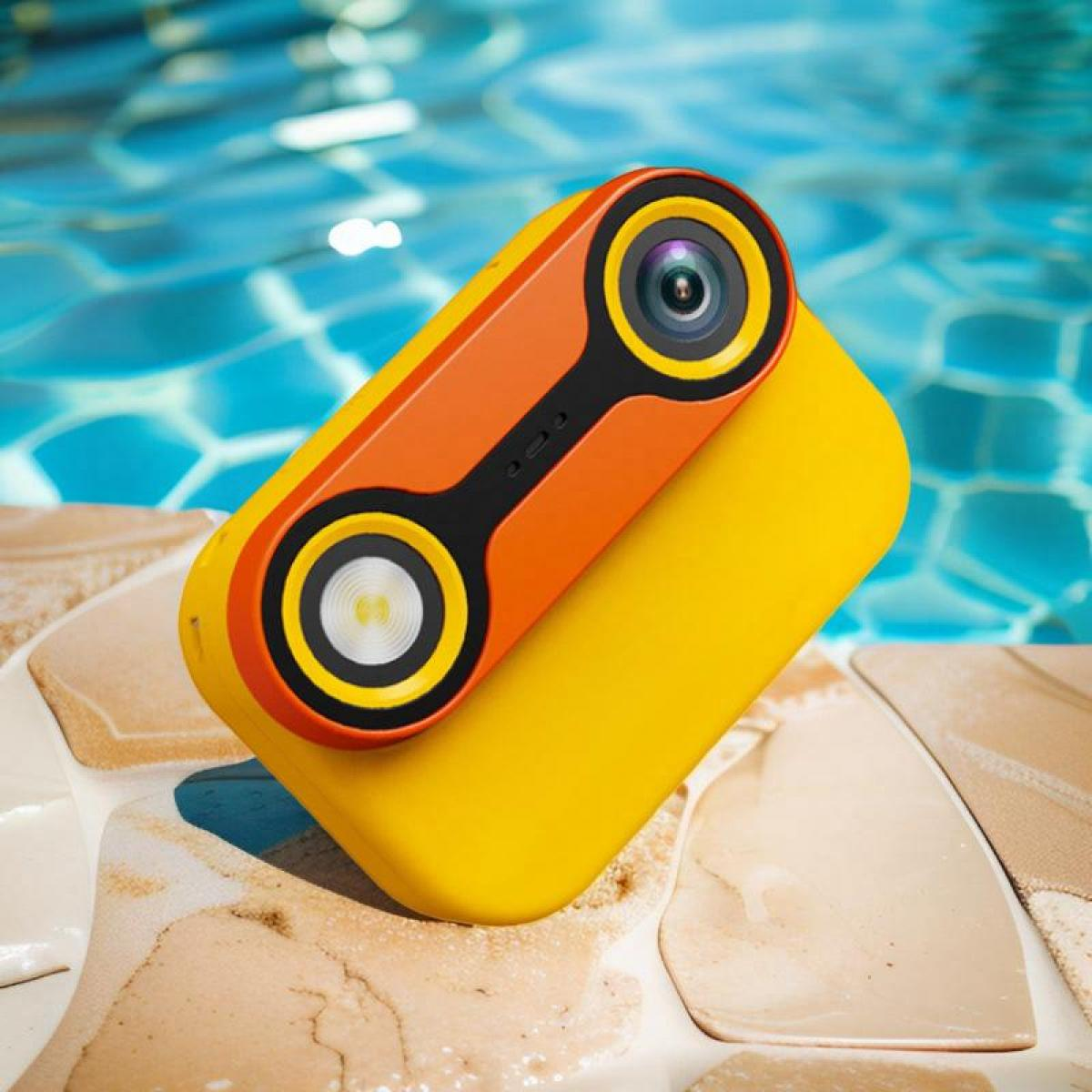 Gelbe und orangefarbene Kamera mit zwei Objektiven neben einem Pool.