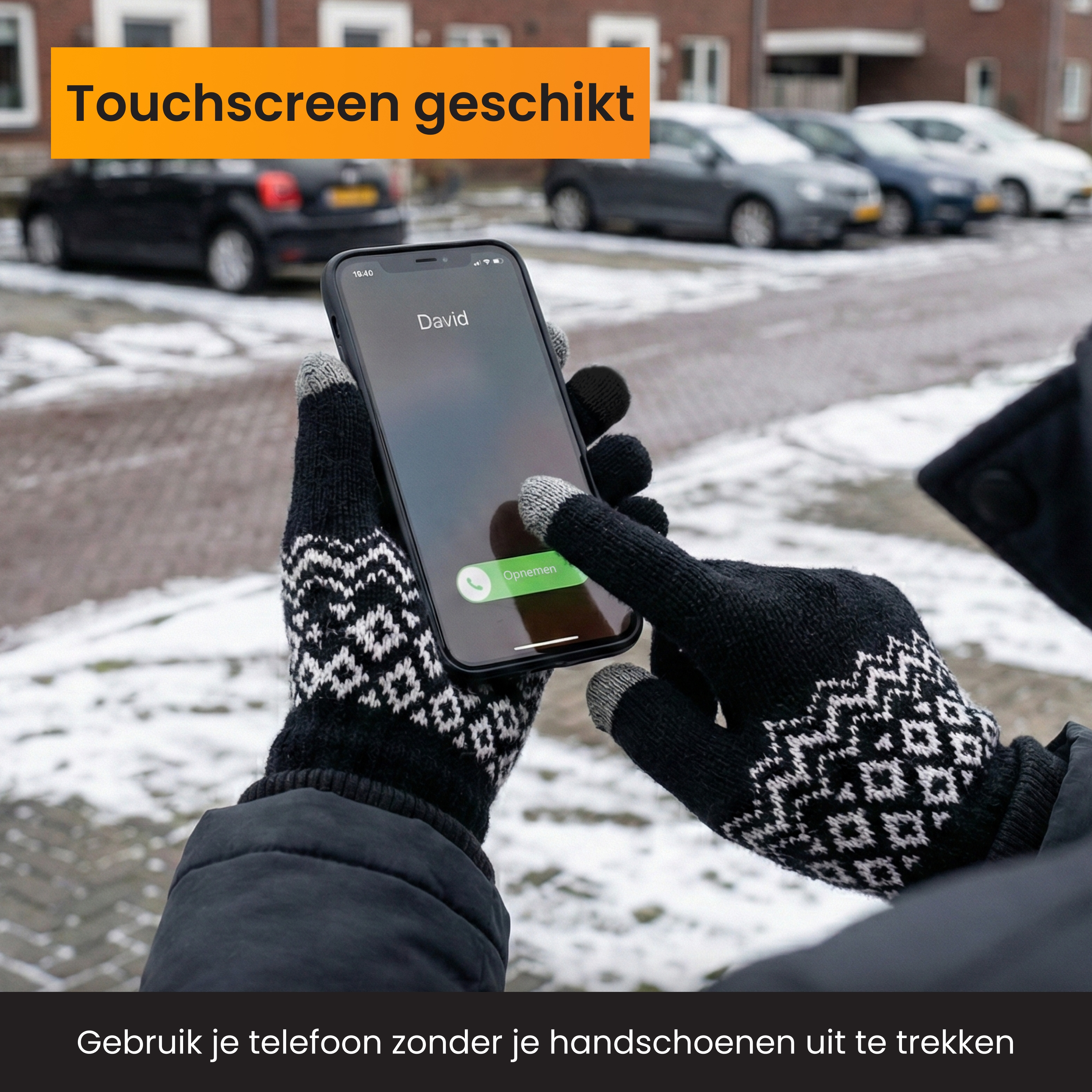Person wearing gloves operates a smartphone in the snow.