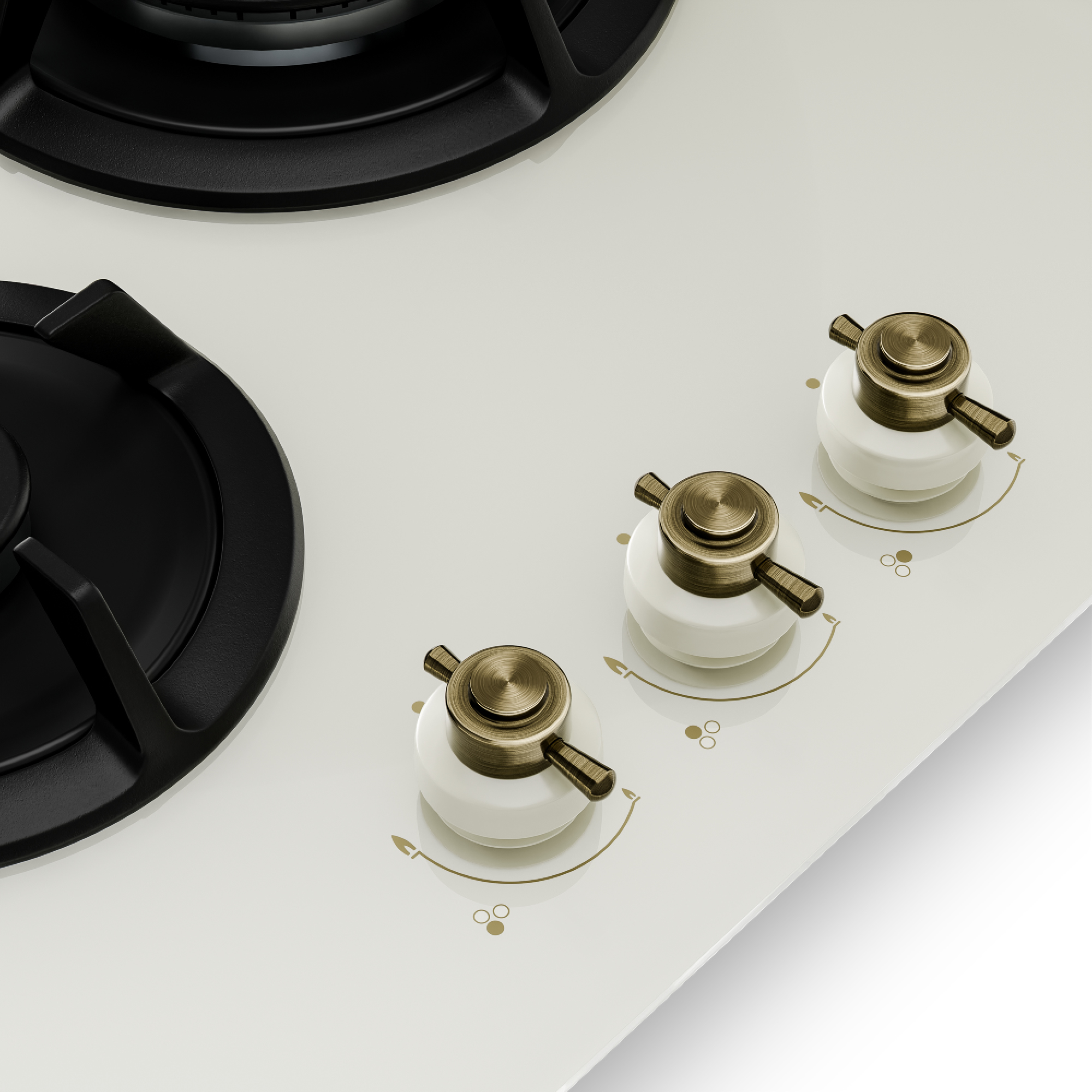 Una cucina color crema con tre fuochi neri e manopole in ottone.