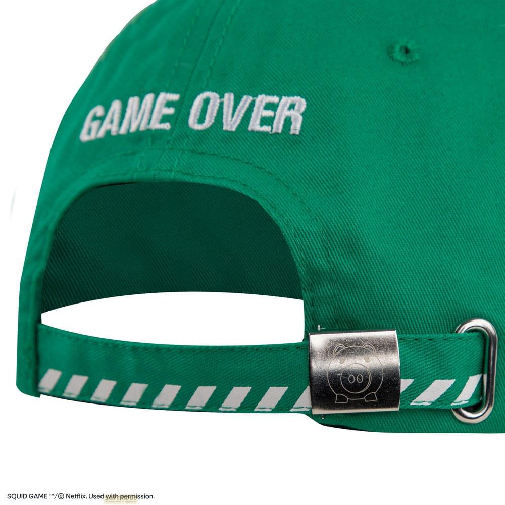 Gorra verde con texto blanco "GAME OVER" y detalles de cerdo.