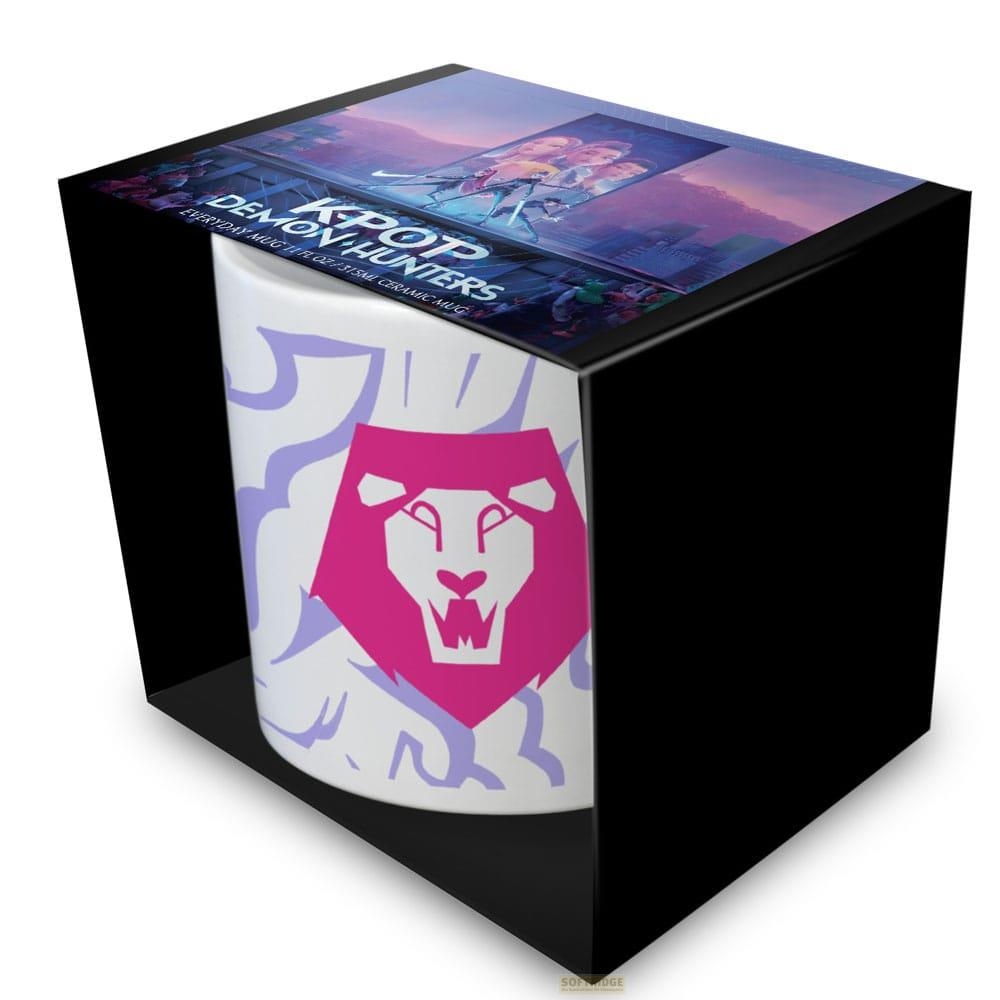 Taza cerámica blanca con cabeza de león rosa y patrón púrpura en caja negra.
