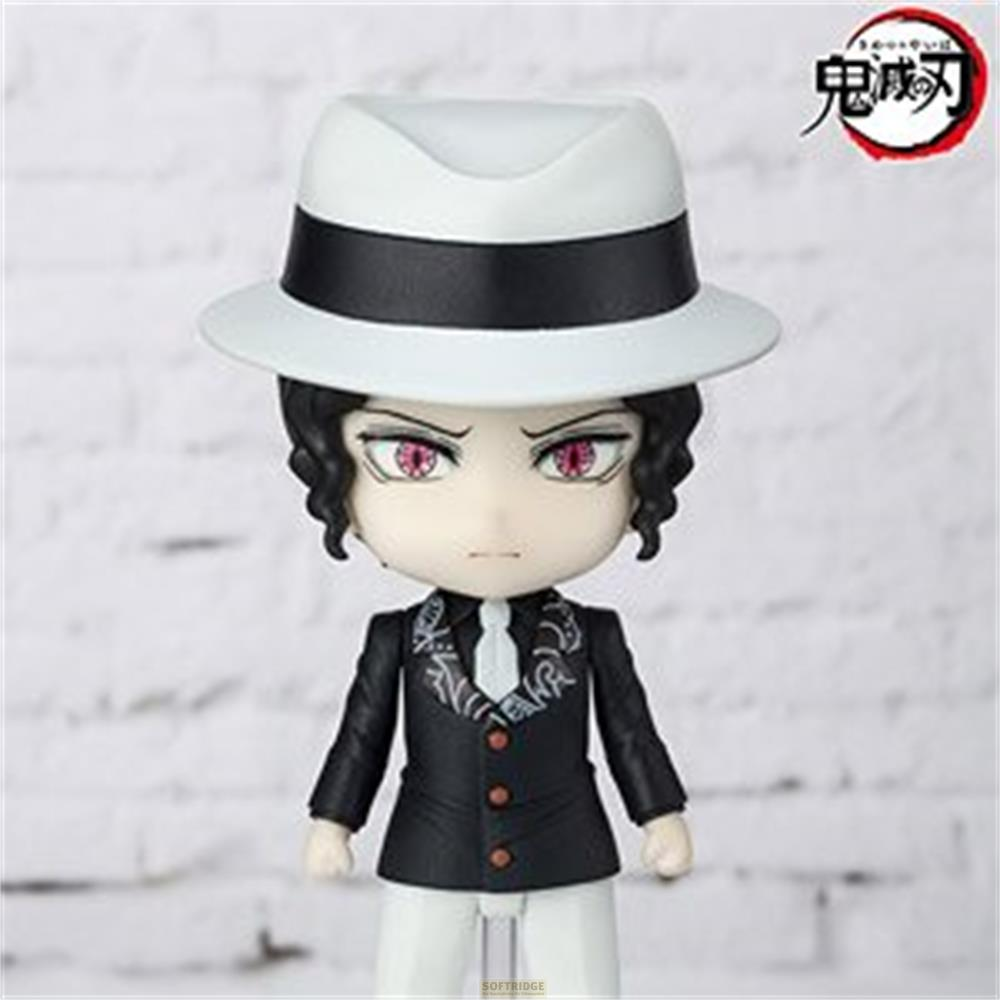 Una figura con cappello bianco, completo nero, camicia bianca e cravatta.