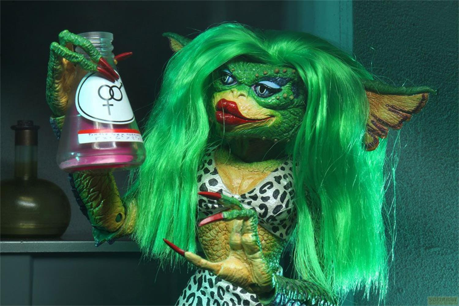 Una gremlin hembra verde con pelo verde brillante y bikini de leopardo sostiene una botella rosa.
