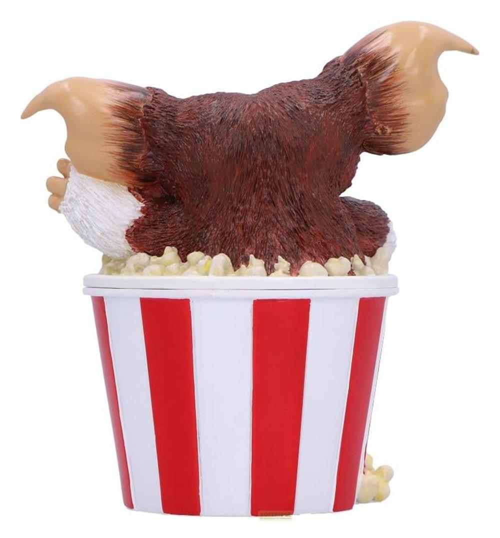 Eine braune Kreatur mit großen Ohren sitzt in einem roten und weißen Eimer mit Popcorn.