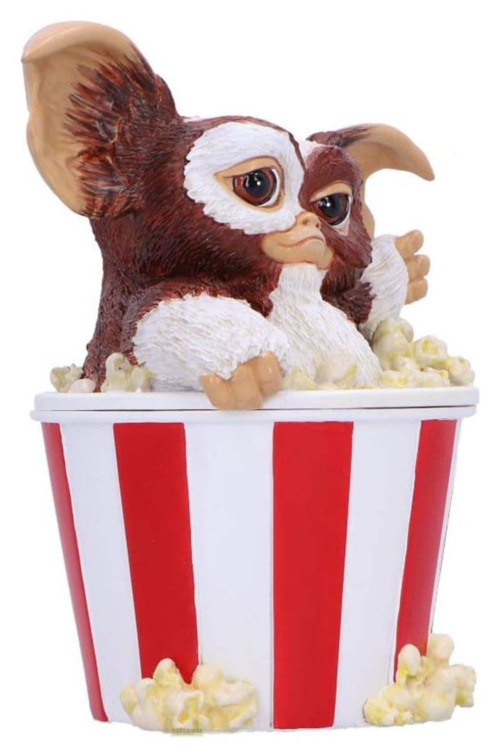Eine Figur eines braunen und weißen Wesens sitzt in einem rot-weißen Popcornbecher.