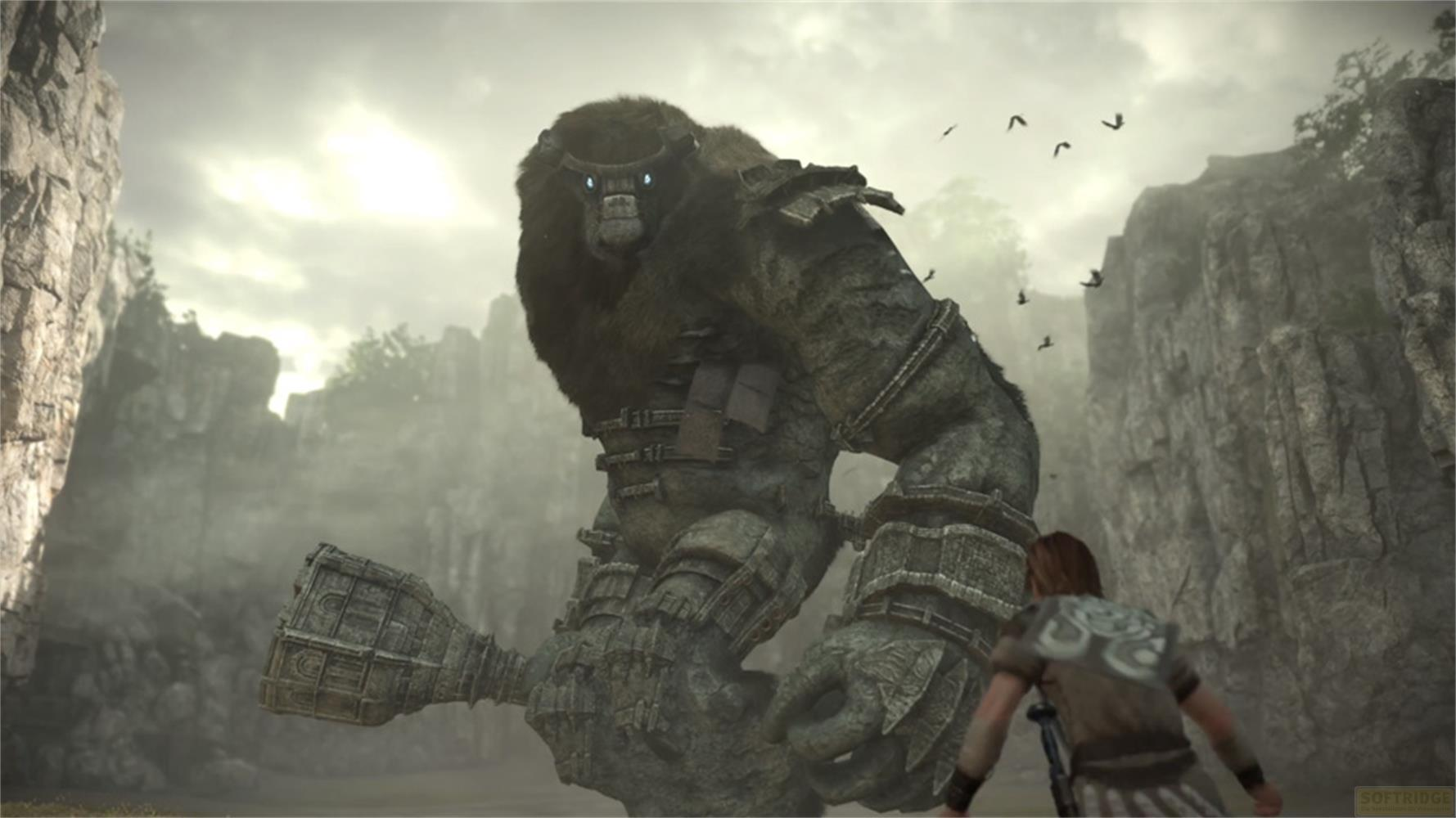 Un golem de pierre géant aux yeux bleus se dresse au-dessus d'un homme dans un paysage rocheux.