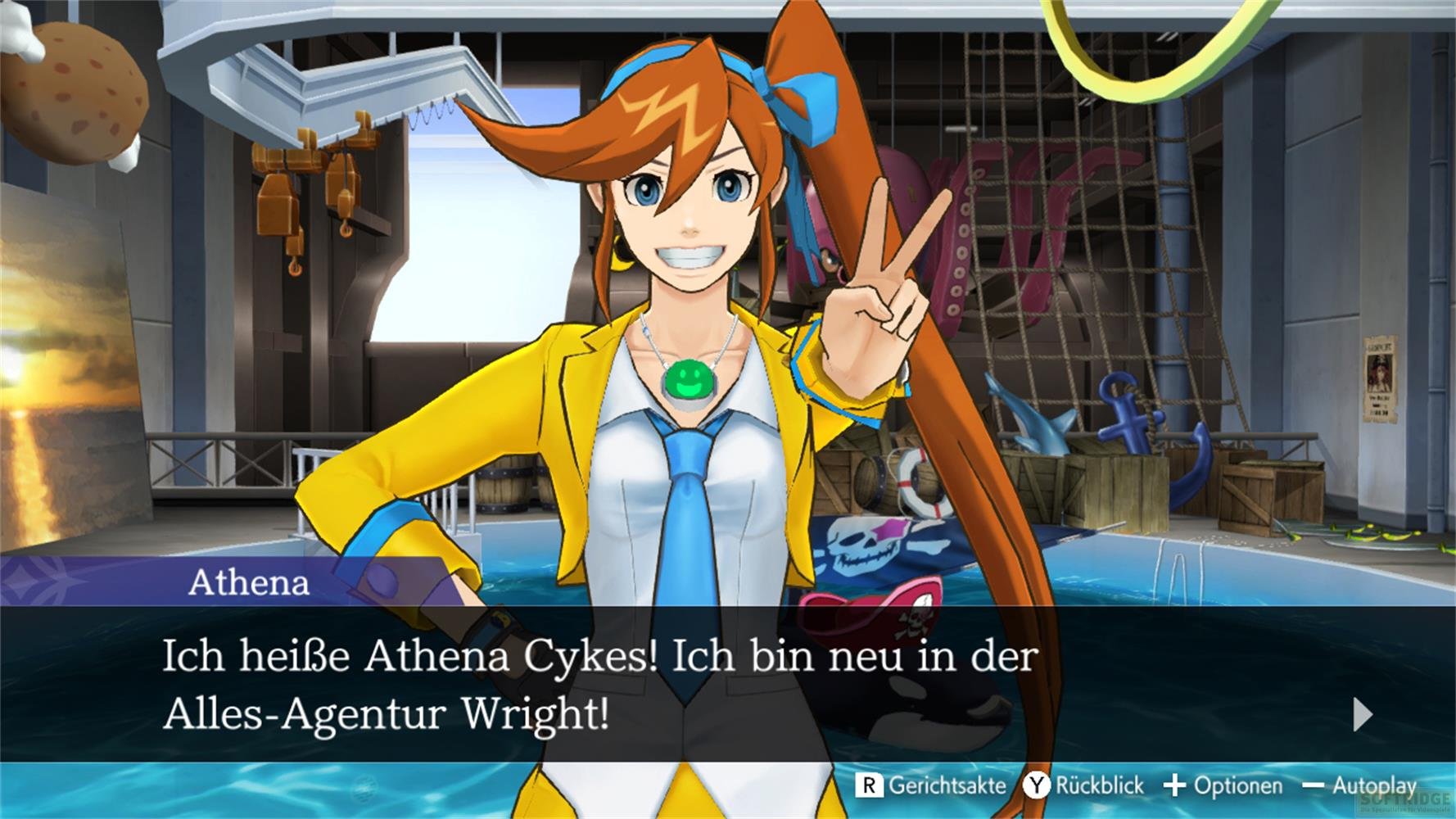 Athena con capelli arancioni, giacca gialla e cravatta blu fa segno V.