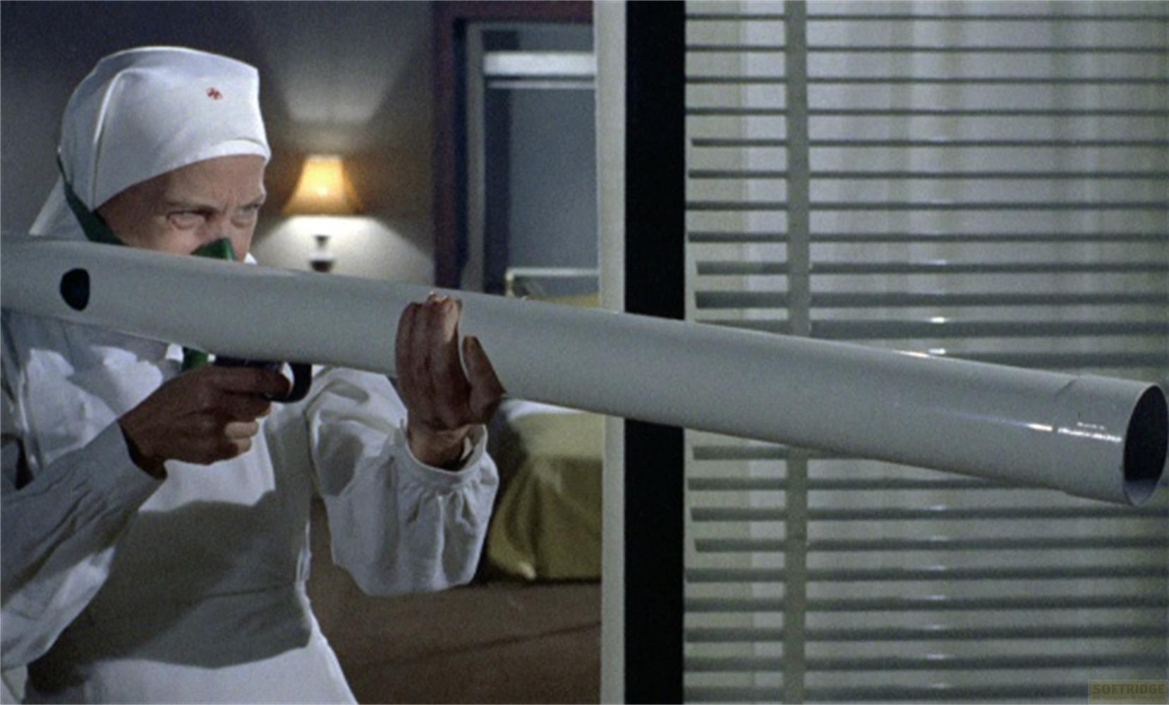 Una donna in uniforme da infermiera punta un lungo tubo.