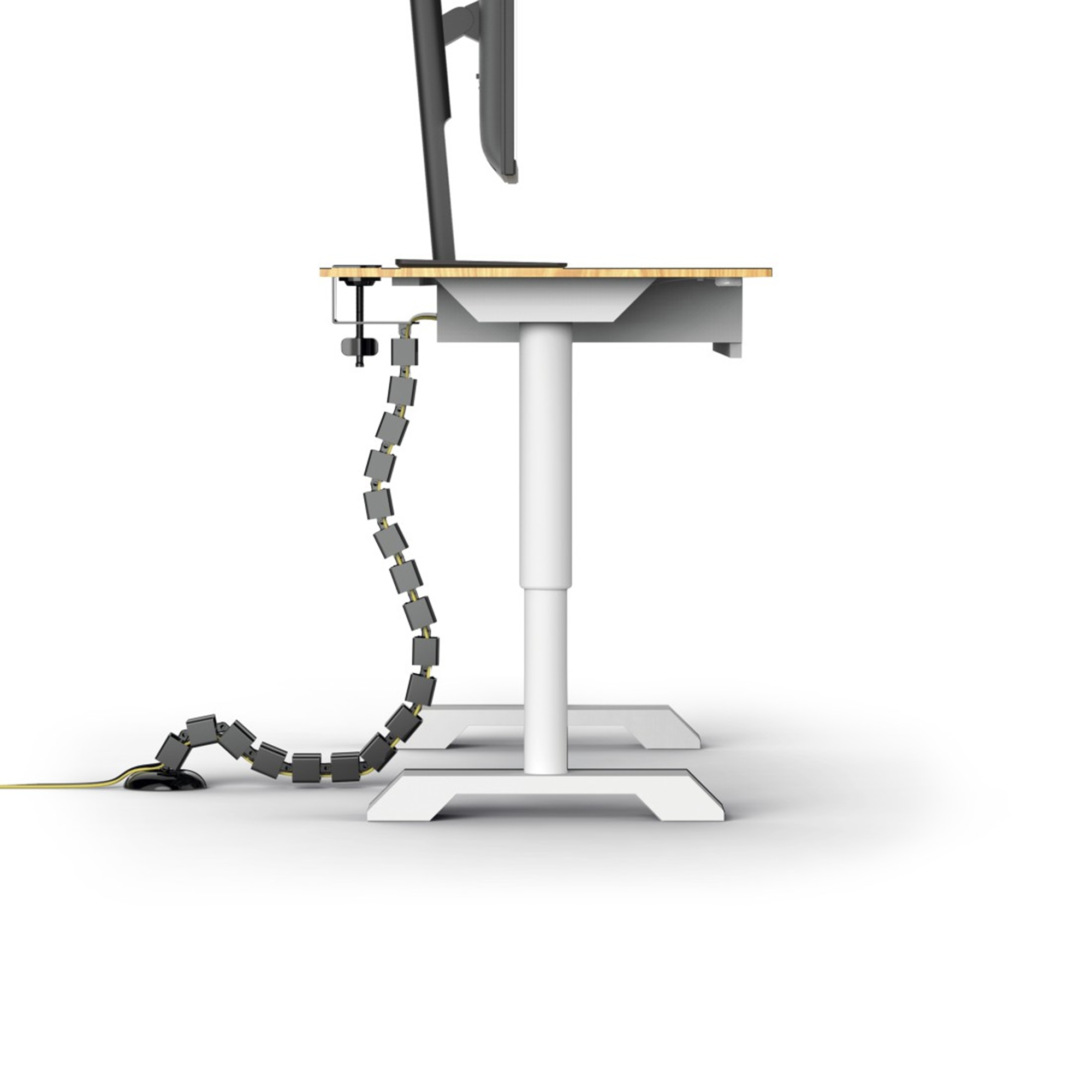 Ein Stehschreibtisch mit Monitor und flexibler Kabelkette.