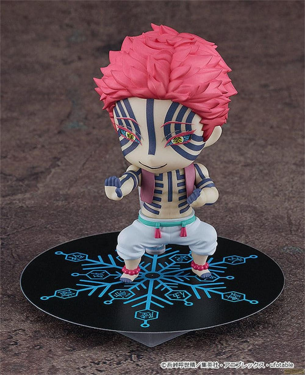 Eine Anime-Figur mit pinkem Haar und blauen Markierungen steht auf einer schwarzen Scheibe mit blauem Muster.