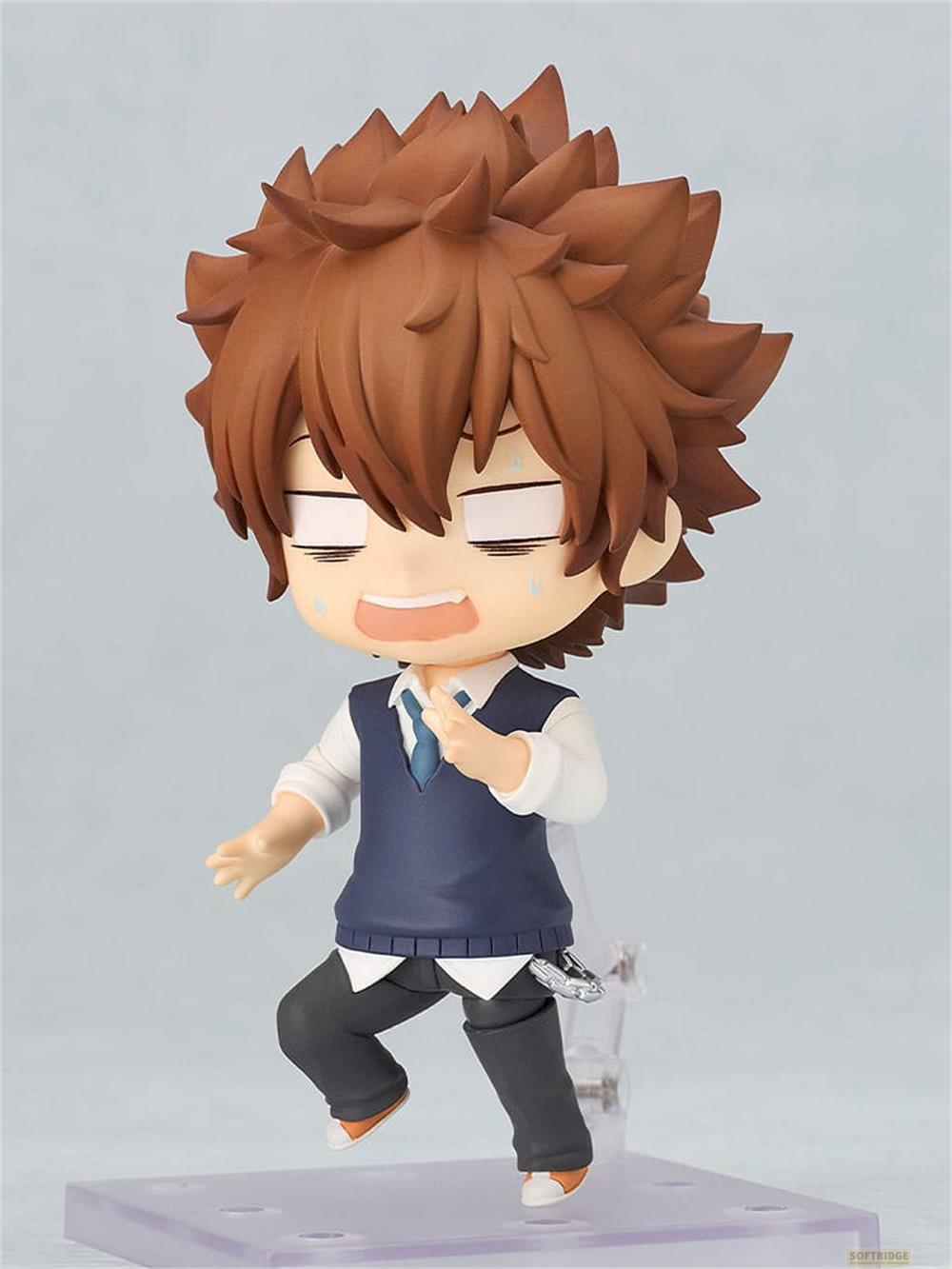 Una statuetta anime con capelli castani a punta, indossa un gilet blu, camicia bianca e cravatta.