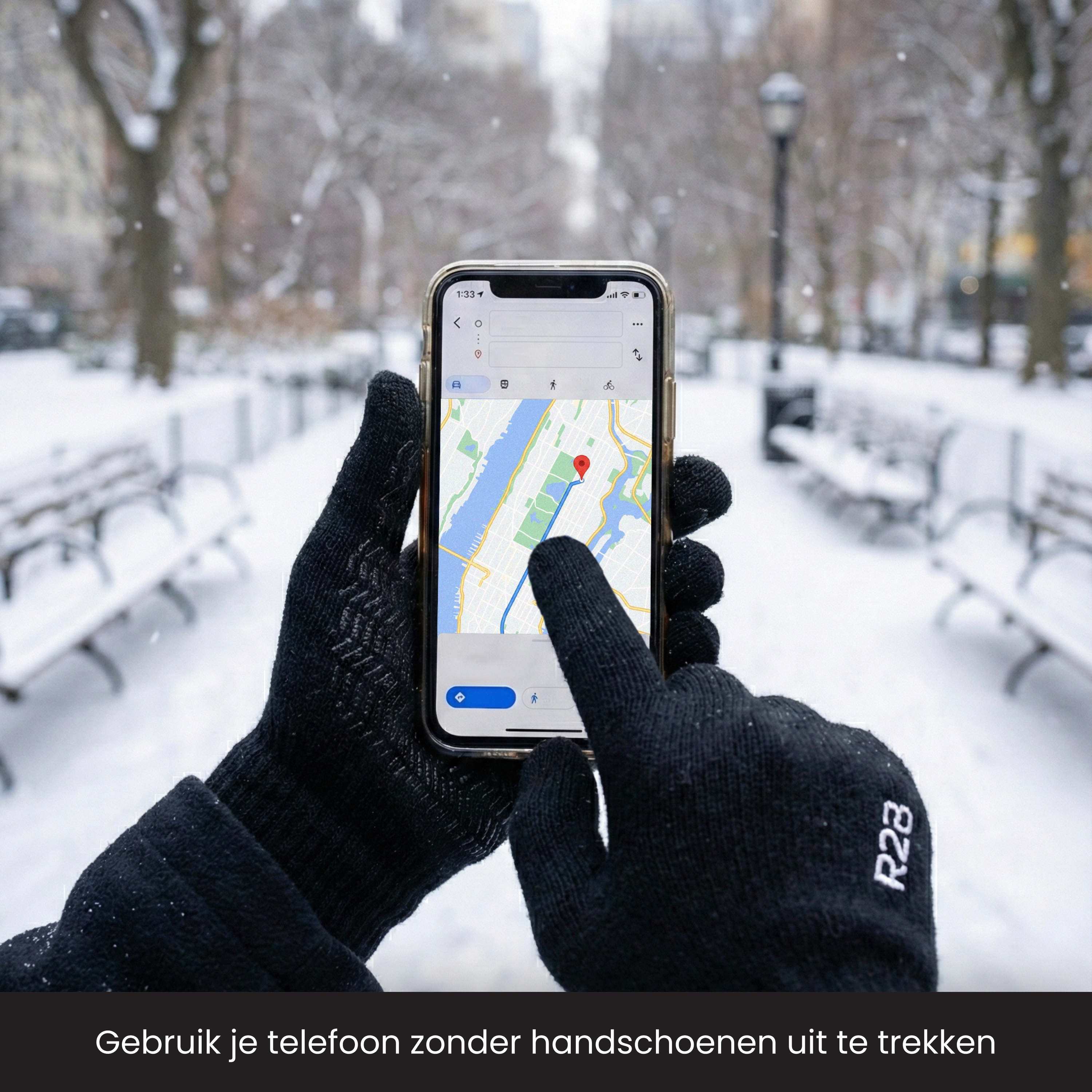 Hands in black gloves operate a smartphone with a navigation app in the snow.
