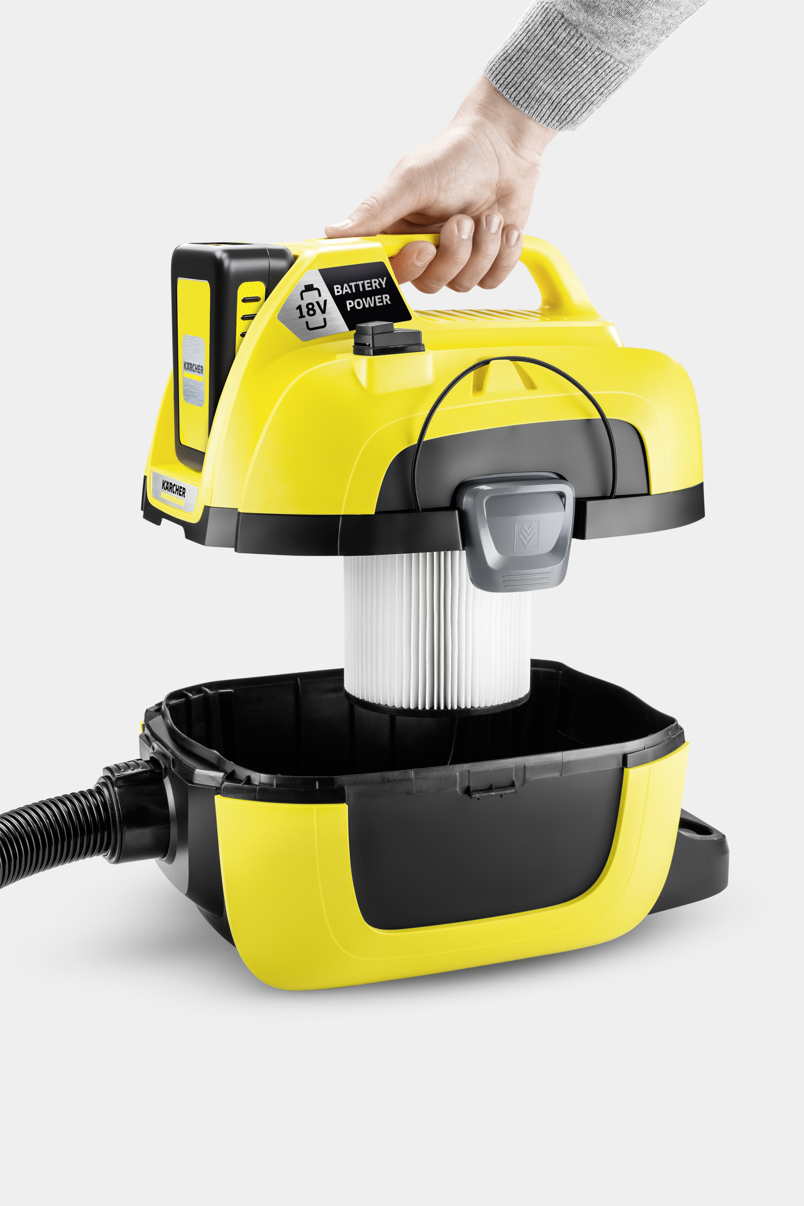 Yellow vacuum cleaner with detached bin, filter, and battery visible.