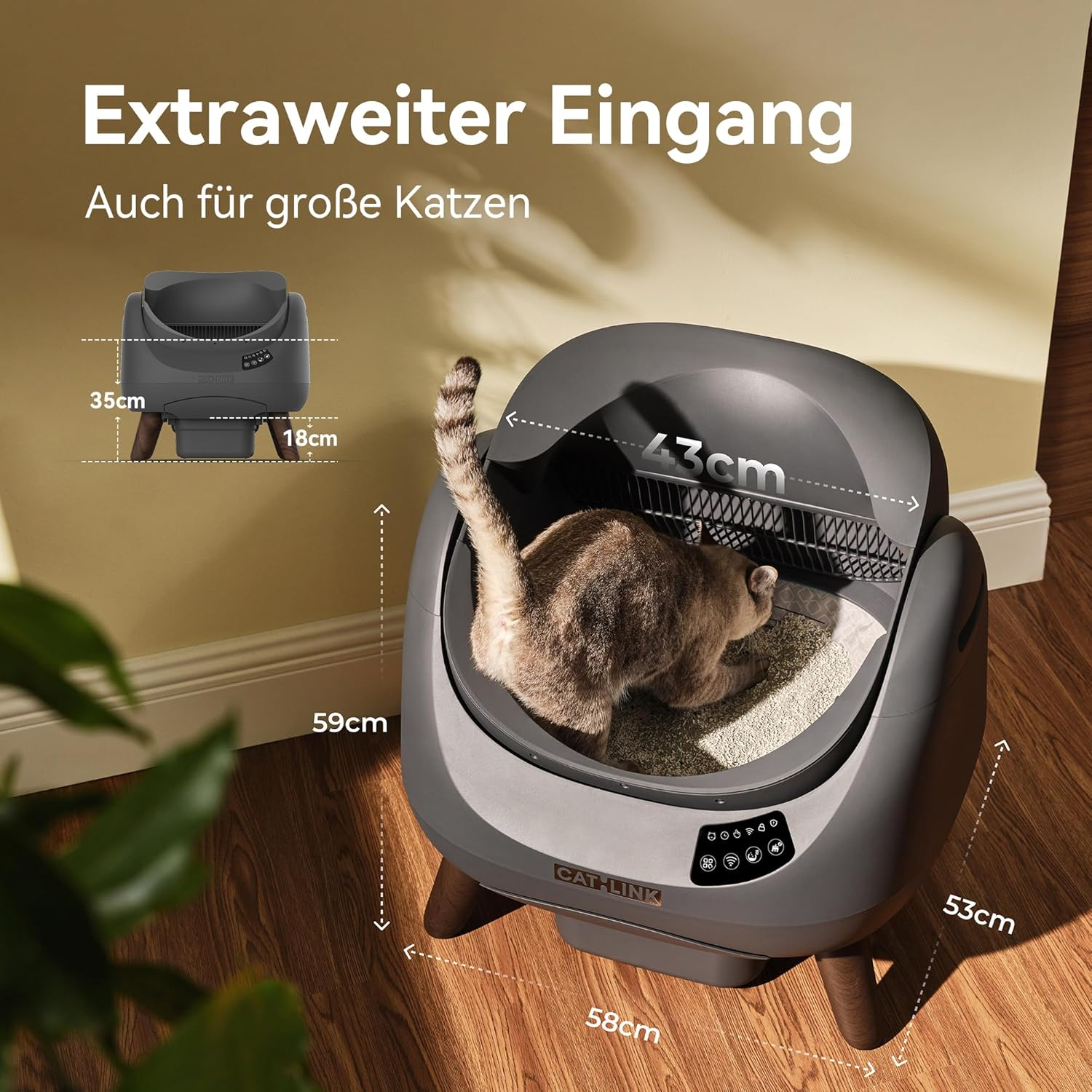 Eine Katze benutzt eine große, graue selbstreinigende Katzentoilette mit breitem Eingang.