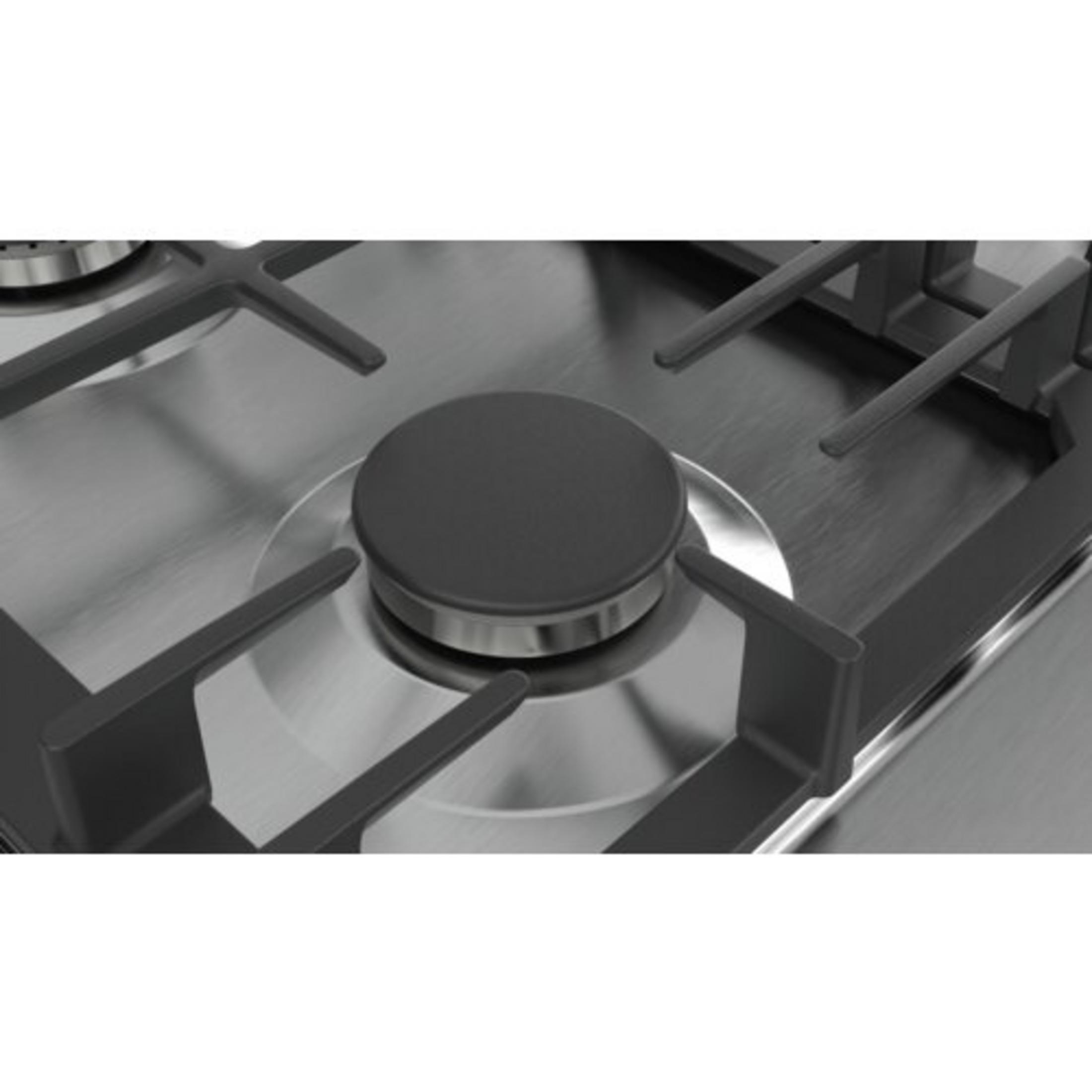 Particolare di un fornello a gas con coperchio bruciatore nero e griglie metalliche.