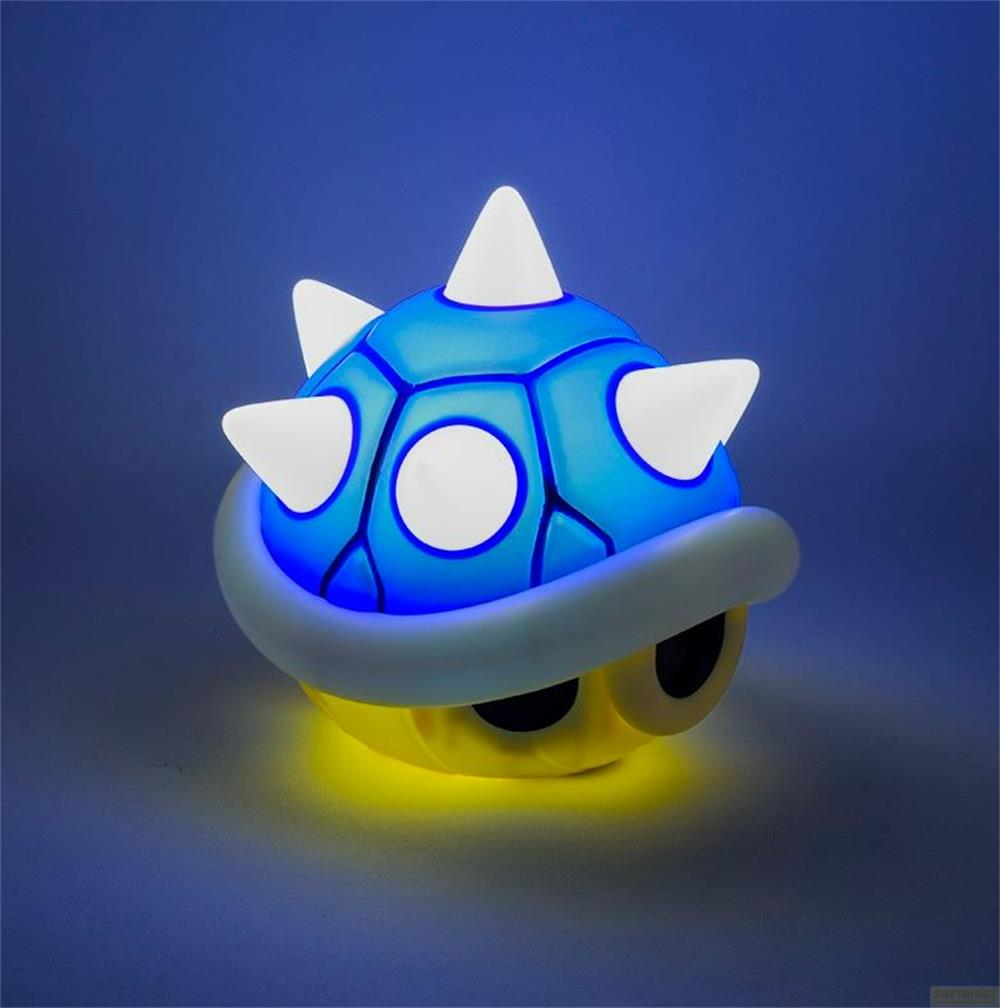 Lámpara de caparazón Koopa azul con púas blancas y luz amarilla debajo.