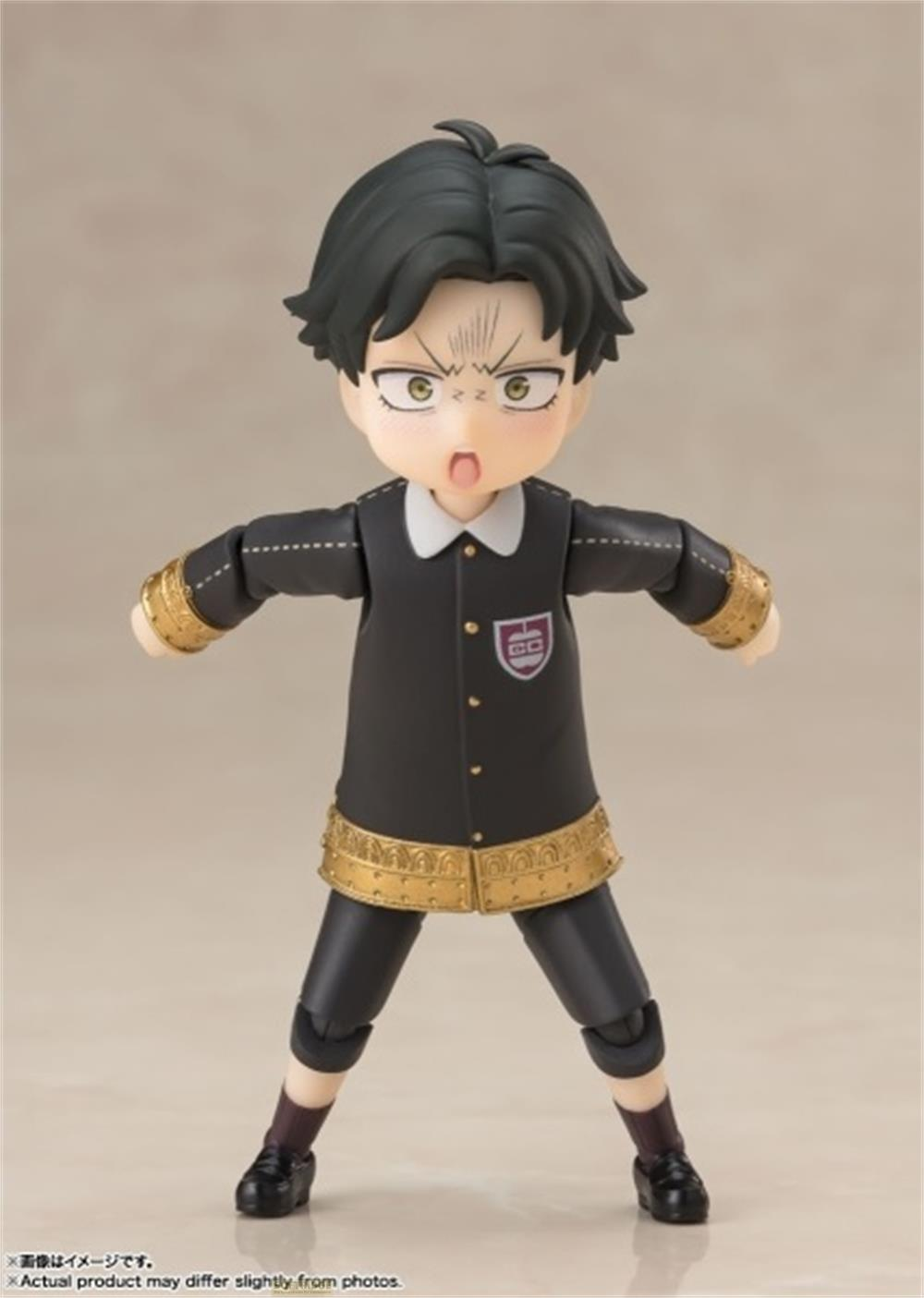 Una statuetta di ragazzo in uniforme scolastica nera con bordo dorato e colletto bianco.